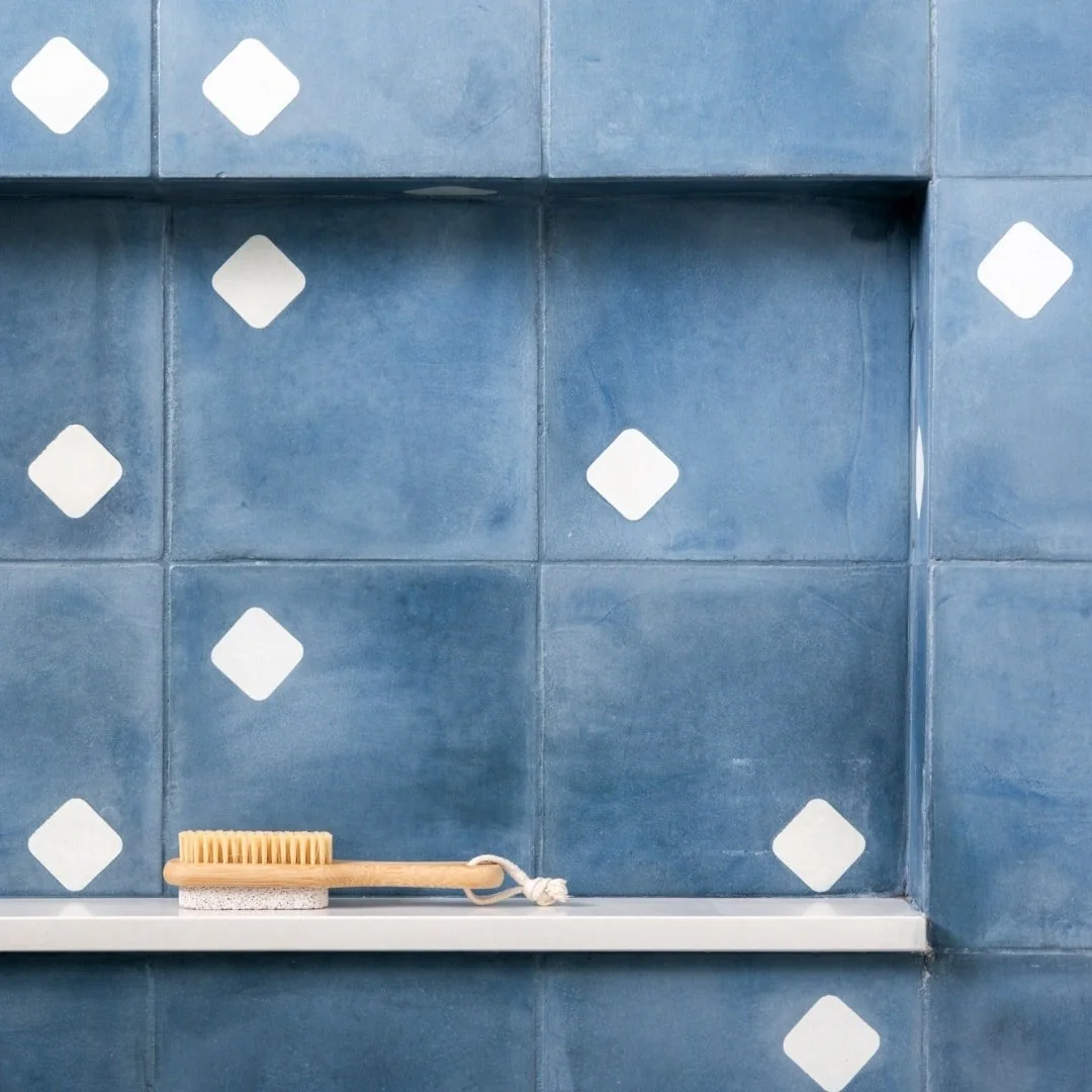 Detalhe de ladrilho hidráulico azul com aplique decorativo branco